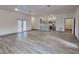 Bright living room featuring sleek flooring that seamlessly connects to an open concept kitchen at 28 Guava Ln, Ocklawaha, FL 32179