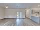 Spacious living room features modern vinyl floors, neutral paint, and lots of natural light at 28 Guava Ln, Ocklawaha, FL 32179