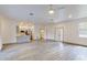 Spacious living room with an open floor plan, flowing to kitchen and front entry at 28 Guava Ln, Ocklawaha, FL 32179