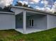 View of the home's covered patio with a ceiling fan and access to the home at 28 Guava Ln, Ocklawaha, FL 32179