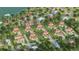 Aerial view of waterfront homes on a sunny day with mature landscaping, private drives, and luxury finishes at 2910 Hardy Ave, New Smyrna Beach, FL 32168