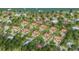 Aerial view of waterfront homes on a sunny day with mature landscaping, private drives, and luxury finishes at 2910 Hardy Ave, New Smyrna Beach, FL 32168