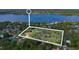 Aerial view showing a property line for a residential property with a large lake nearby and surrounded by woods at 2910 Hardy Ave, New Smyrna Beach, FL 32168
