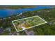 Panoramic aerial view of a tree-covered property near a beautiful waterfront, offering privacy and scenic beauty at 2910 Hardy Ave, New Smyrna Beach, FL 32168