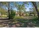 Lush backyard with mature trees providing ample shade and privacy at 2910 Hardy Ave, New Smyrna Beach, FL 32168