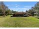 Spacious backyard featuring a covered patio area and large lawn at 2910 Hardy Ave, New Smyrna Beach, FL 32168