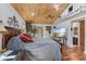 Primary bedroom features a wood plank ceiling, hardwood floors, and natural light from windows at 2910 Hardy Ave, New Smyrna Beach, FL 32168