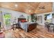 Primary bedroom with wood plank ceiling, hardwood floors, large windows, and a decorative design at 2910 Hardy Ave, New Smyrna Beach, FL 32168