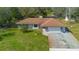 Charming one-story home with a manicured lawn and a two-car garage with stone accents at 2910 Hardy Ave, New Smyrna Beach, FL 32168