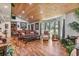 Bright living room with vaulted wood ceilings, hardwood floors, and ample natural light at 2910 Hardy Ave, New Smyrna Beach, FL 32168