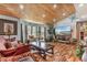 Cozy living room with wood floors, tongue and groove ceiling, bay window and stylish furnishings at 2910 Hardy Ave, New Smyrna Beach, FL 32168