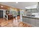 Spacious living room featuring hardwood floors, a wood plank ceiling, and seamless flow into the kitchen at 2910 Hardy Ave, New Smyrna Beach, FL 32168