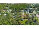 Aerial perspective of a home nestled among verdant foliage, complemented by neighborhood houses and a tree-lined street at 2918 Hardy Ave, New Smyrna Beach, FL 32168
