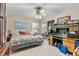 Comfortable bedroom featuring neutral walls, a patterned quilt, and a unique desk with built-in storage at 2918 Hardy Ave, New Smyrna Beach, FL 32168