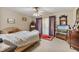 Bright bedroom with ample natural light, ceiling fan, tile floors, and vintage dresser at 2918 Hardy Ave, New Smyrna Beach, FL 32168