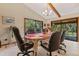 Bright dining area with large windows, tile flooring, and seating for several people at 2918 Hardy Ave, New Smyrna Beach, FL 32168