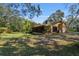Charming single-story home with an ample lawn, screened porch, and a picturesque, tree-filled setting at 2918 Hardy Ave, New Smyrna Beach, FL 32168