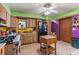 Eclectic kitchen with natural wood cabinets, yellow and purple walls, and a center prep island at 2918 Hardy Ave, New Smyrna Beach, FL 32168