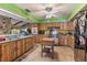 Bright kitchen boasts rustic wooden cabinetry, tile floors, and modern stainless steel appliances at 2918 Hardy Ave, New Smyrna Beach, FL 32168