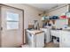 Functional laundry room with washer, dryer, storage shelves and door to the exterior at 2918 Hardy Ave, New Smyrna Beach, FL 32168