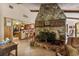 Living room featuring a stone fireplace, tile flooring, and an open view to the kitchen at 2918 Hardy Ave, New Smyrna Beach, FL 32168