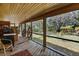 Relaxing screened porch with wood deck, outdoor seating and view of the lush backyard at 2918 Hardy Ave, New Smyrna Beach, FL 32168
