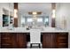 Elegant bathroom featuring dual sinks, wooden cabinetry, and ample counter space at 297 N Beach St, Ormond Beach, FL 32174