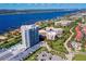This aerial view features the condo building near the Halifax River, Intracoastal Waterway and lush green landscape at 3 Oceans West Blvd # 1D6, Daytona Beach Shores, FL 32118