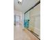 Bright bathroom features travertine flooring, a glass-enclosed shower, and updated fixtures at 3 Oceans West Blvd # 1D6, Daytona Beach Shores, FL 32118