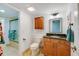 Small bathroom with toilet, vanity, shower, and tiled floor at 3 Oceans West Blvd # 1D6, Daytona Beach Shores, FL 32118