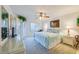 Bright bedroom with a ceiling fan, plantation shutters, and coastal-themed decor at 3 Oceans West Blvd # 1D6, Daytona Beach Shores, FL 32118