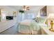 Bright bedroom with a ceiling fan, plantation shutters, and coastal-themed decor at 3 Oceans West Blvd # 1D6, Daytona Beach Shores, FL 32118