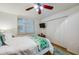 This bedroom features a ceiling fan, a window with plantation shutters, and closet at 3 Oceans West Blvd # 1D6, Daytona Beach Shores, FL 32118