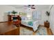 Cozy bedroom with a ceiling fan, a window with plantation shutters, and a hardwood floor at 3 Oceans West Blvd # 1D6, Daytona Beach Shores, FL 32118