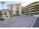 Exterior of condo building with parking garage and brick paved driveway at 3 Oceans West Blvd # 1D6, Daytona Beach Shores, FL 32118