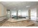 Bright indoor hot tub area with large windows, tile flooring, columns and a tiled spa with seating at 3 Oceans West Blvd # 1D6, Daytona Beach Shores, FL 32118