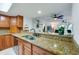 Kitchen with stainless steel sink and granite countertops, open to living area at 3 Oceans West Blvd # 1D6, Daytona Beach Shores, FL 32118