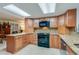 Bright kitchen featuring granite countertops, stainless steel appliances, and wood cabinets at 3 Oceans West Blvd # 1D6, Daytona Beach Shores, FL 32118
