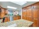 Kitchen showcasing granite countertops and cabinetry providing ample storage space at 3 Oceans West Blvd # 1D6, Daytona Beach Shores, FL 32118