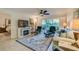 Living room with fireplace, balcony access, and comfortable seating at 3 Oceans West Blvd # 1D6, Daytona Beach Shores, FL 32118