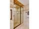 Close-up of glass enclosed shower with beautiful tile work and bronze hardware at 3 Oceans West Blvd # 1D6, Daytona Beach Shores, FL 32118