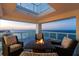 Inviting outdoor seating area with fire pit table on a private balcony overlooking the ocean at sunset at 3000 N Atlantic Ave # 24, Daytona Beach, FL 32118