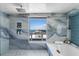 Bright bathroom features a soaking tub and an ocean view from the large window at 3000 N Atlantic Ave # 24, Daytona Beach, FL 32118