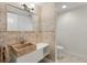 Charming bathroom featuring a stone sink, mosaic tile accents, and modern fixtures at 3000 N Atlantic Ave # 24, Daytona Beach, FL 32118