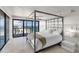 Bright bedroom with floor to ceiling windows overlooking the ocean, and a modern four-poster bed at 3000 N Atlantic Ave # 24, Daytona Beach, FL 32118
