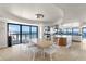 Bright dining room with a modern dining table and expansive ocean views through floor to ceiling windows at 3000 N Atlantic Ave # 24, Daytona Beach, FL 32118