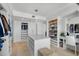 Bright dressing room featuring an island, desk, custom cabinetry, and ample storage at 3000 N Atlantic Ave # 24, Daytona Beach, FL 32118