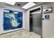 Modern elevator and artistic wall decor in the building's lobby at 3000 N Atlantic Ave # 24, Daytona Beach, FL 32118
