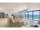 Bright living room with a large sectional sofa and expansive ocean views through floor to ceiling windows at 3000 N Atlantic Ave # 24, Daytona Beach, FL 32118