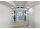 Hallway entrance to a unit with frosted-glass doors, elevator access, and an entry console at 3000 N Atlantic Ave # 24, Daytona Beach, FL 32118